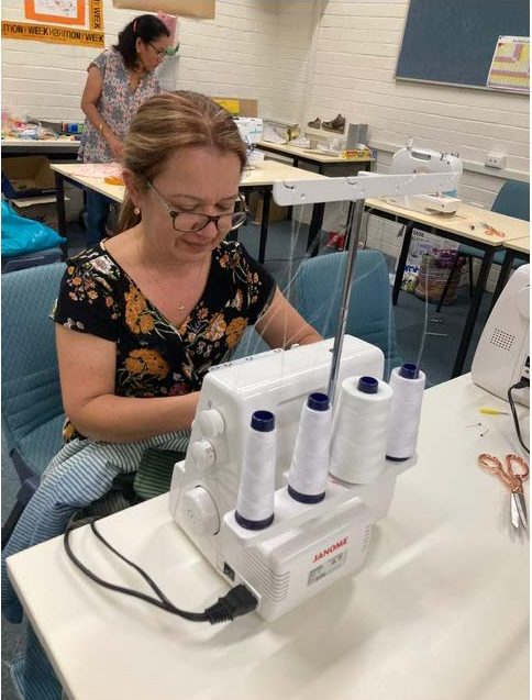 Jo teaching me how to use an overlocker.